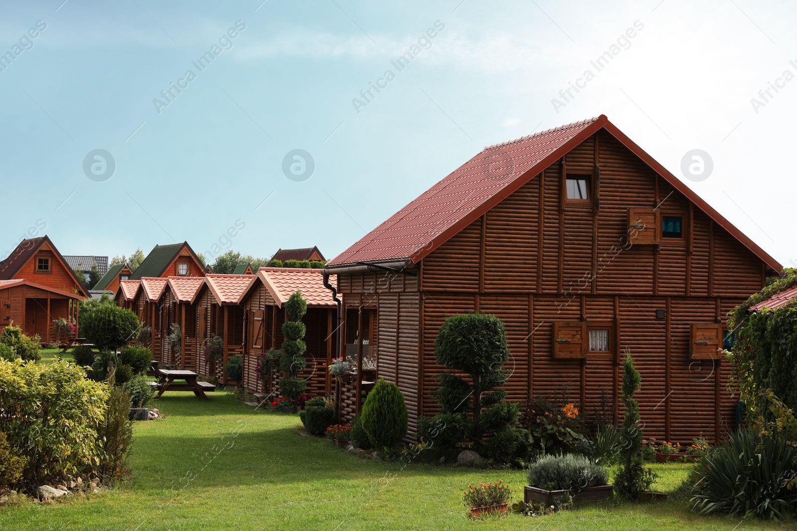 Photo of Beautiful wooden beach houses and green trees outdoors