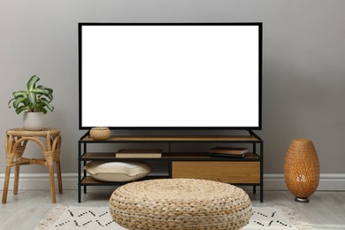 Image of Modern TV set on stand in room