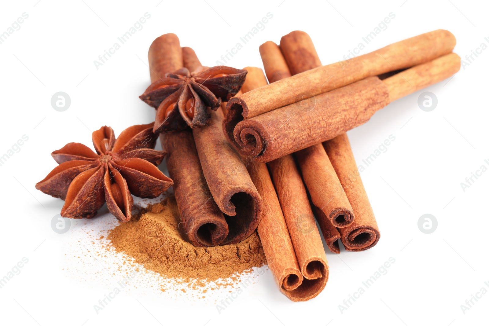 Photo of Dry aromatic cinnamon sticks, powder and anise stars isolated on white