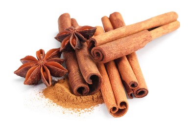 Photo of Dry aromatic cinnamon sticks, powder and anise stars isolated on white