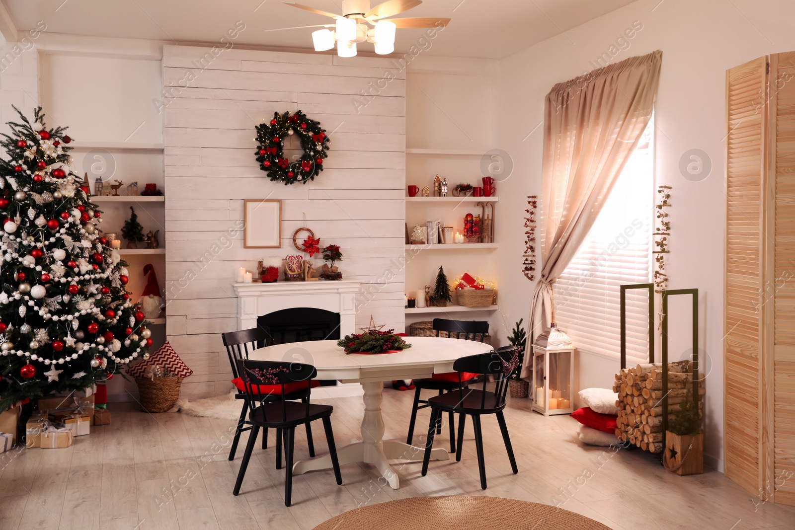 Photo of Cozy dining room interior with Christmas tree and festive decor