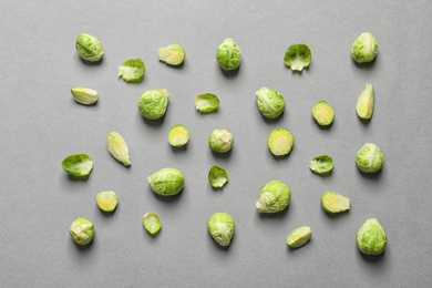 Tasty fresh Brussels sprouts on grey background, top view