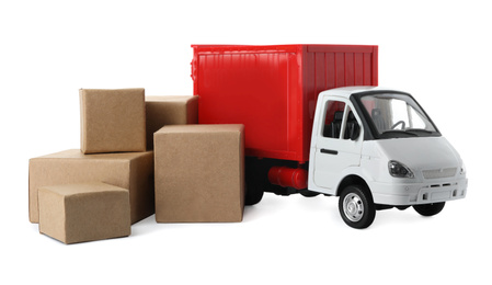 Photo of Toy truck with boxes isolated on white. Logistics and wholesale concept