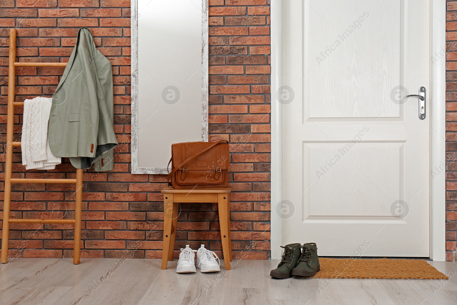 Photo of Hallway interior with shoes, mirror and mat near door