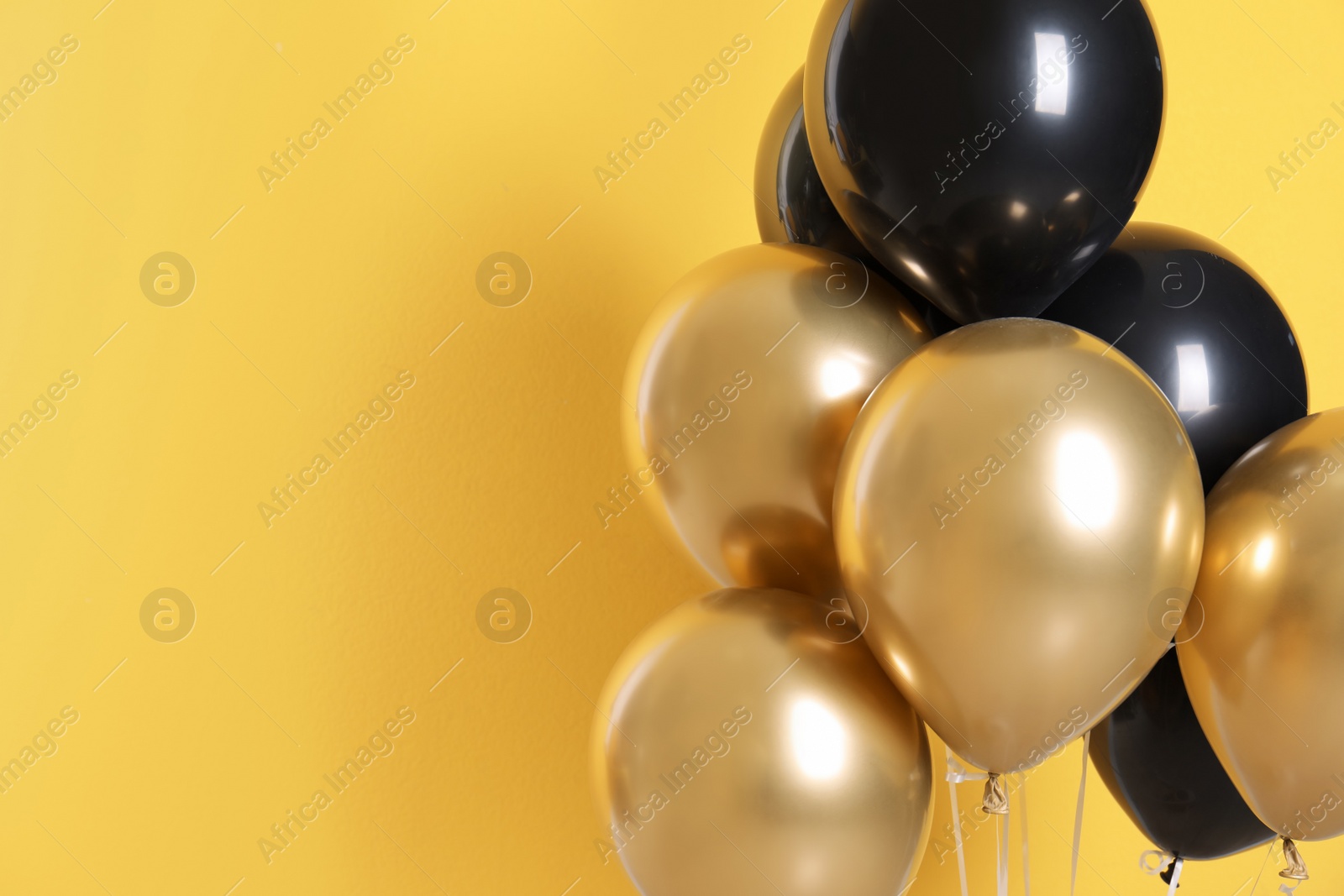 Photo of Different helium party balloons on color background. Space for text