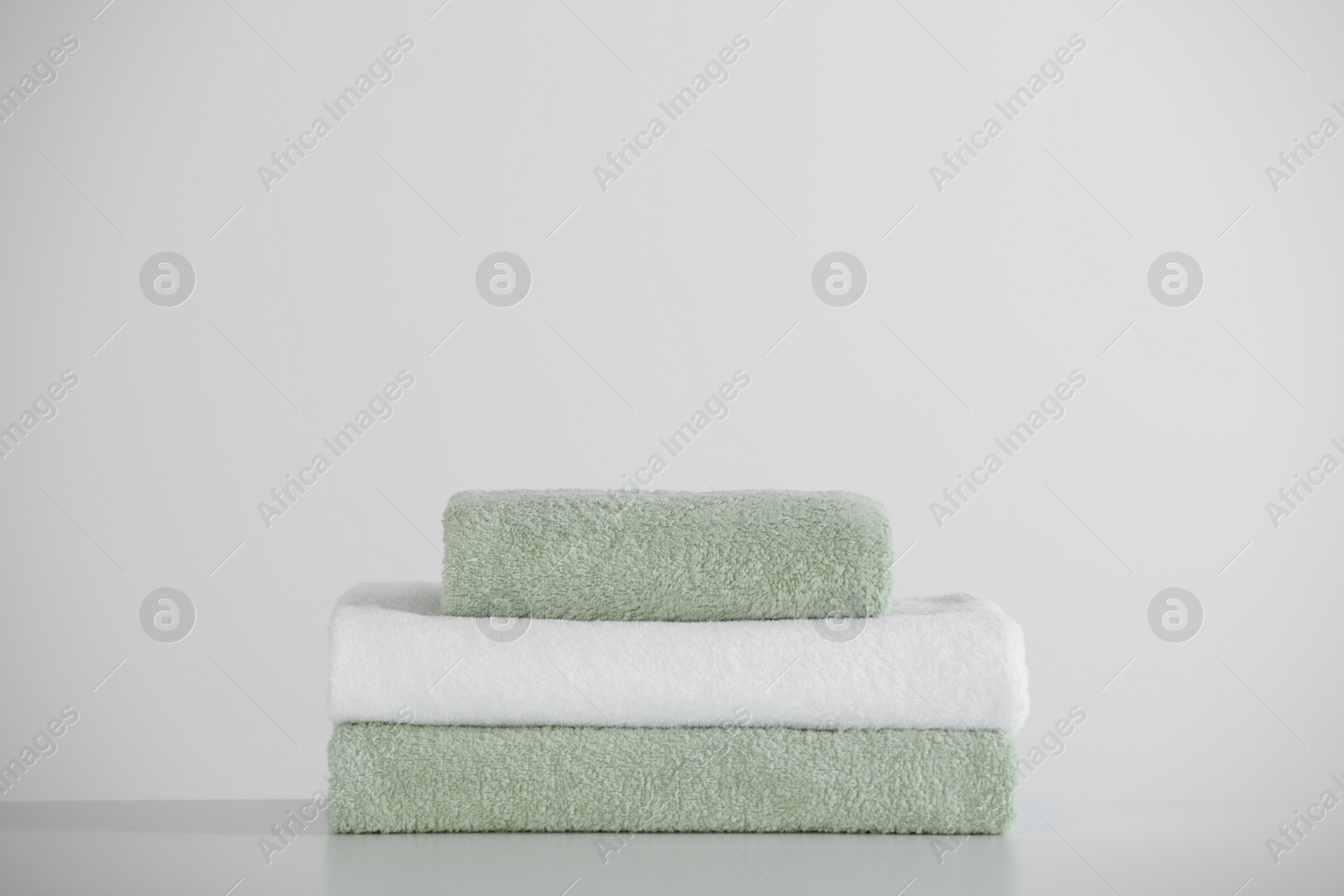 Photo of Stack of folded towels on white table