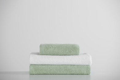 Photo of Stack of folded towels on white table