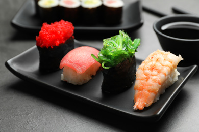 Set of delicious sushi on grey table