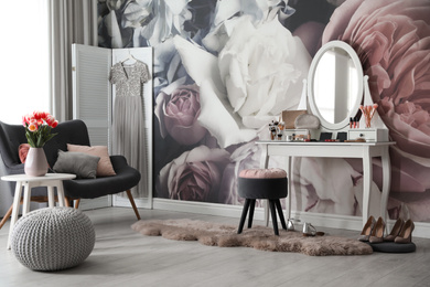 Photo of Stylish room interior with elegant dressing table, sofa and floral wallpaper