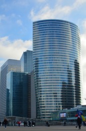 Cityscape with people walking and different modern skyscrapers