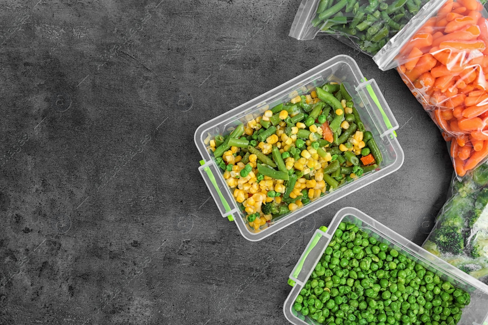 Photo of Different frozen vegetables on table, top view