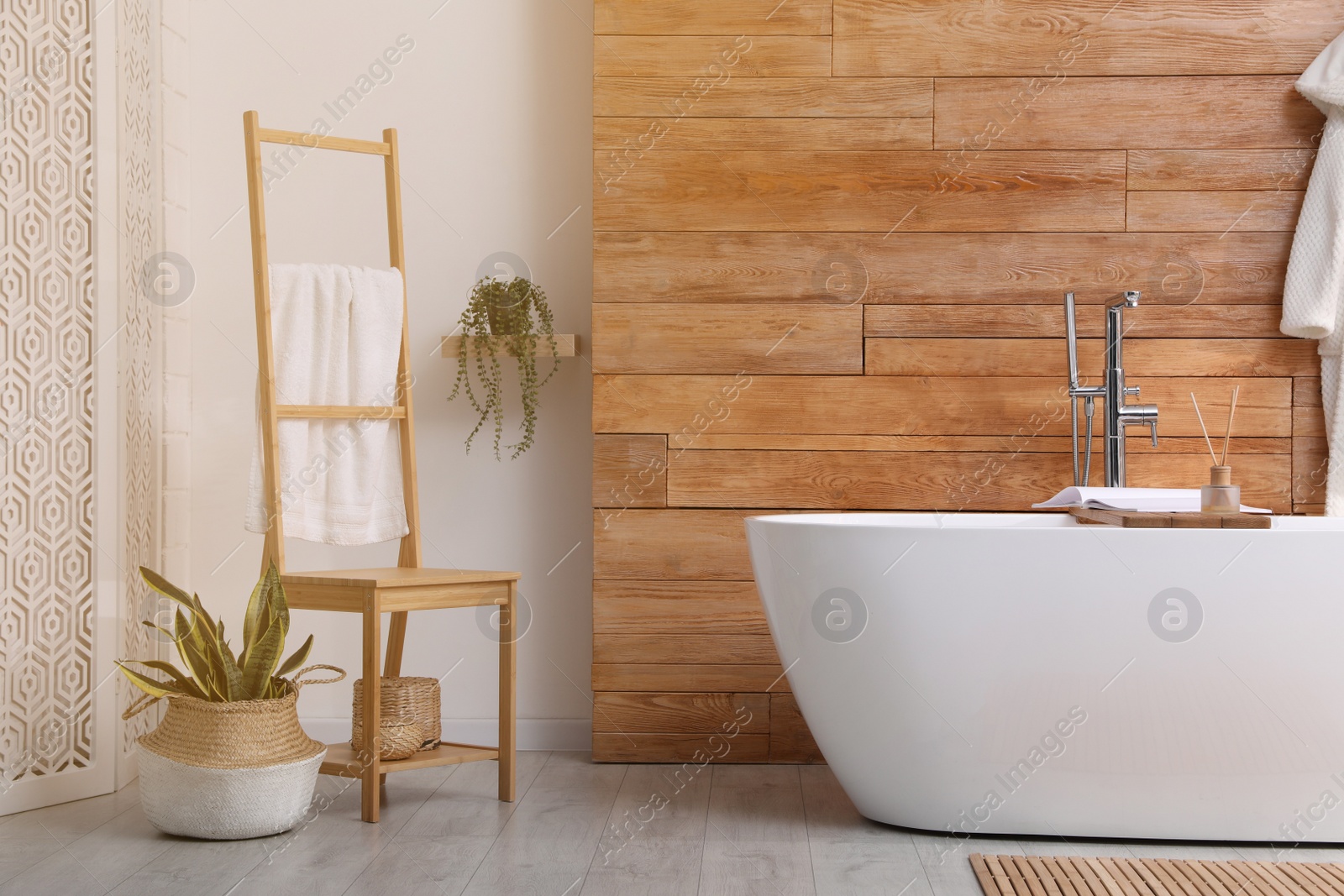 Photo of White tub and beautiful plants in bathroom, Interior design