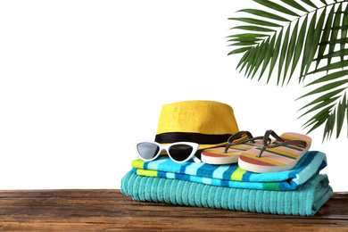 Composition with different beach objects on wooden table, white background