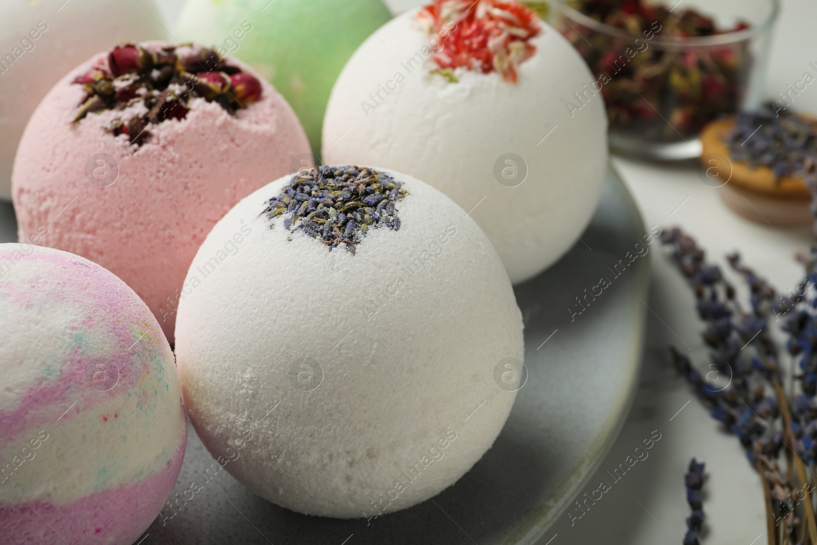 Photo of Plate with different bath bombs on table, closeup