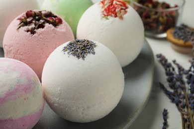 Photo of Plate with different bath bombs on table, closeup
