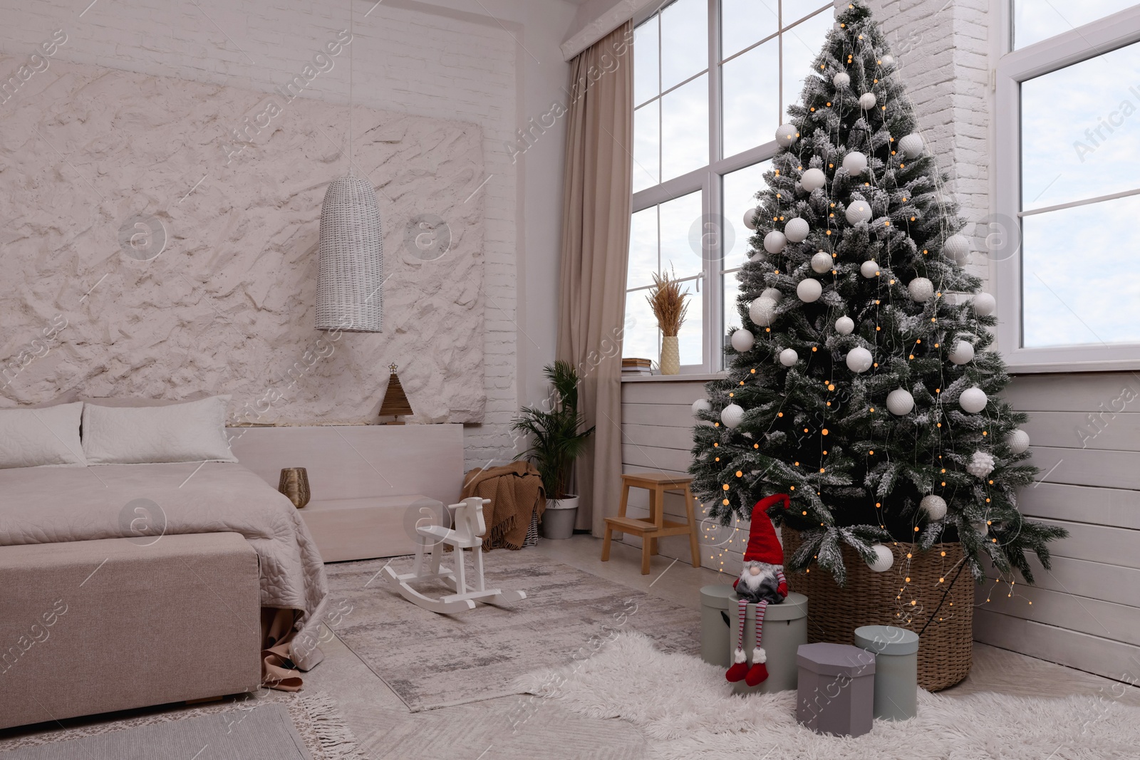 Photo of Bedroom interior with Christmas tree and festive decor