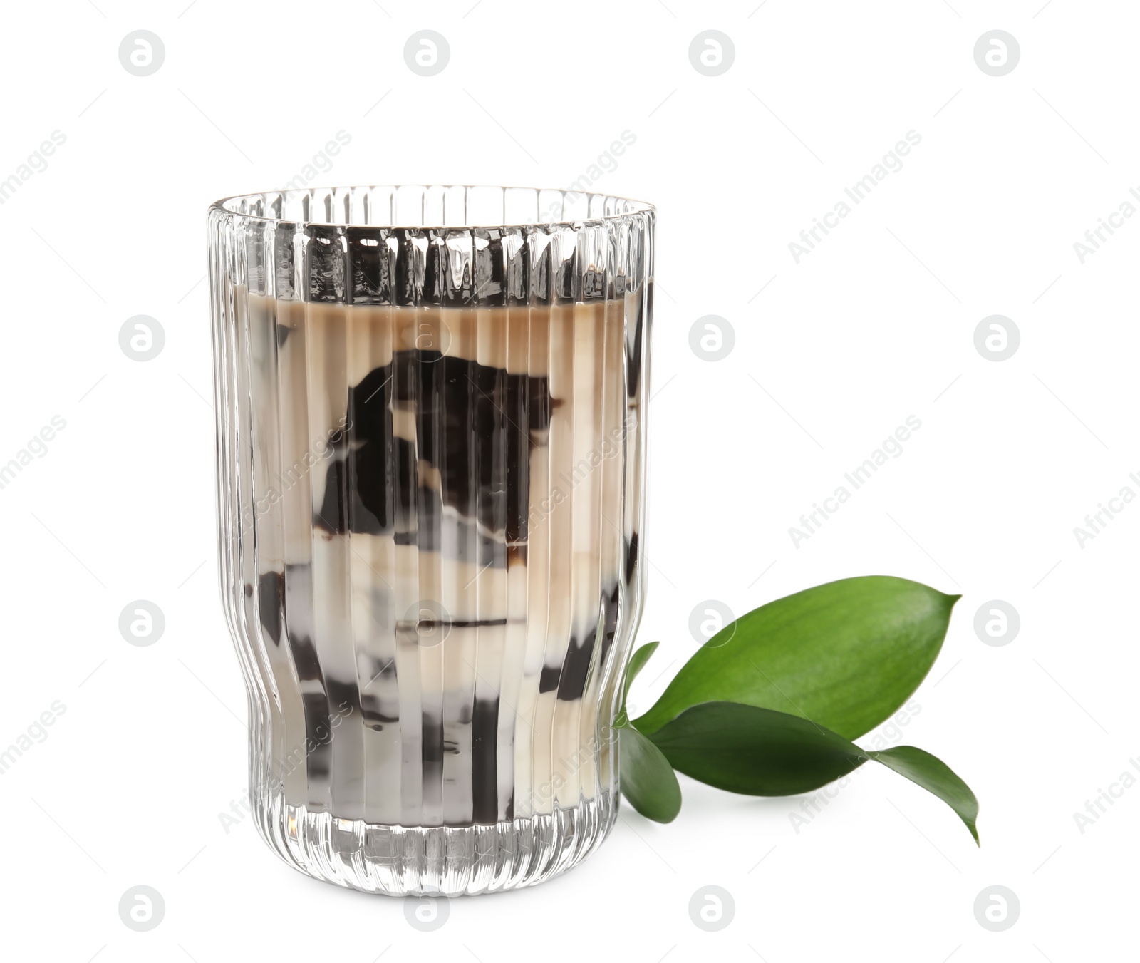 Photo of Glass of milk with grass jelly and green leaves on white background