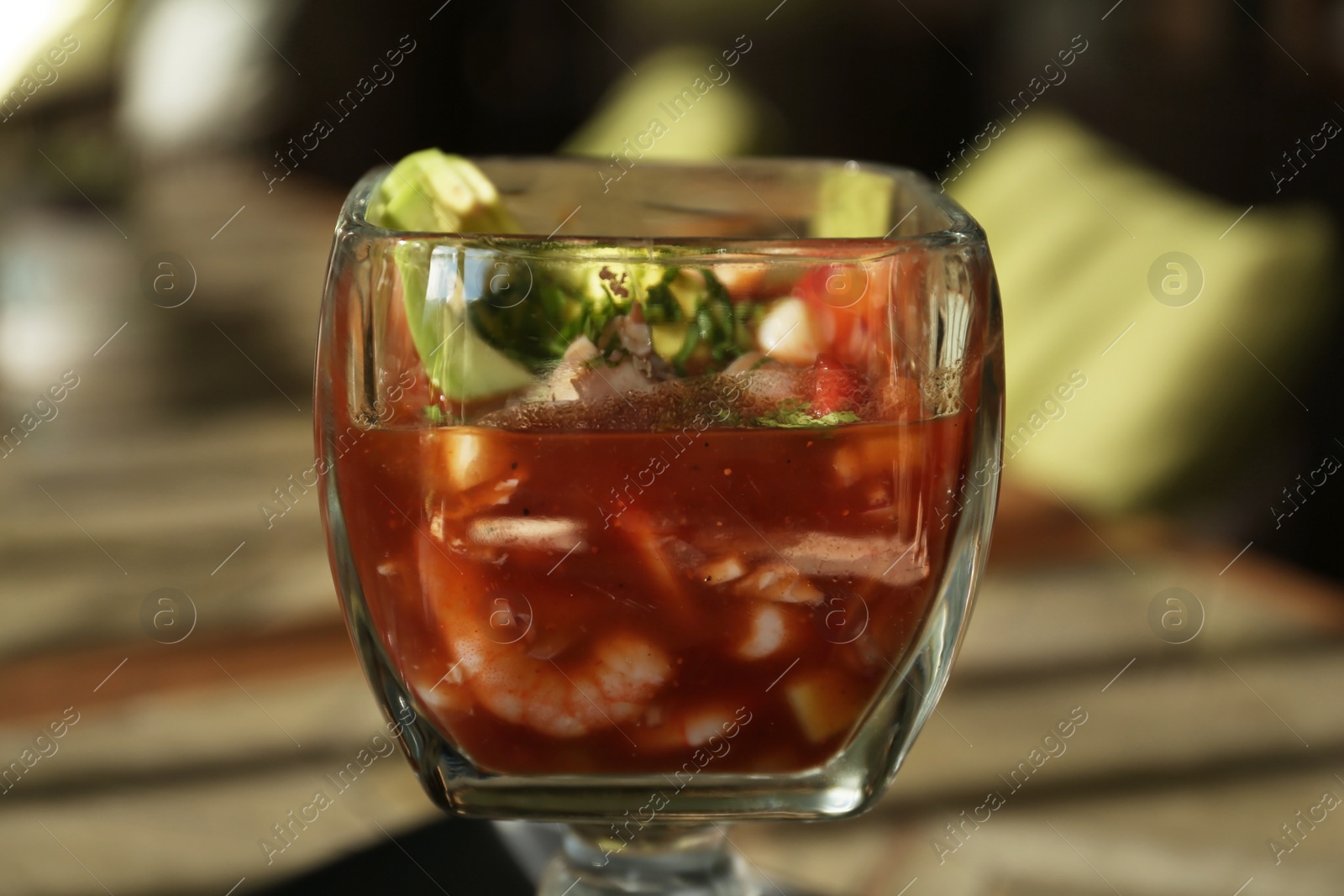 Photo of Delicious campechana cocktail with shrimps on table, closeup