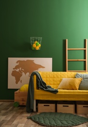 Modern room interior with sofa and wooden crates. Eco style