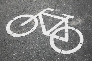 Photo of Bicycle lane with white sign painted on asphalt