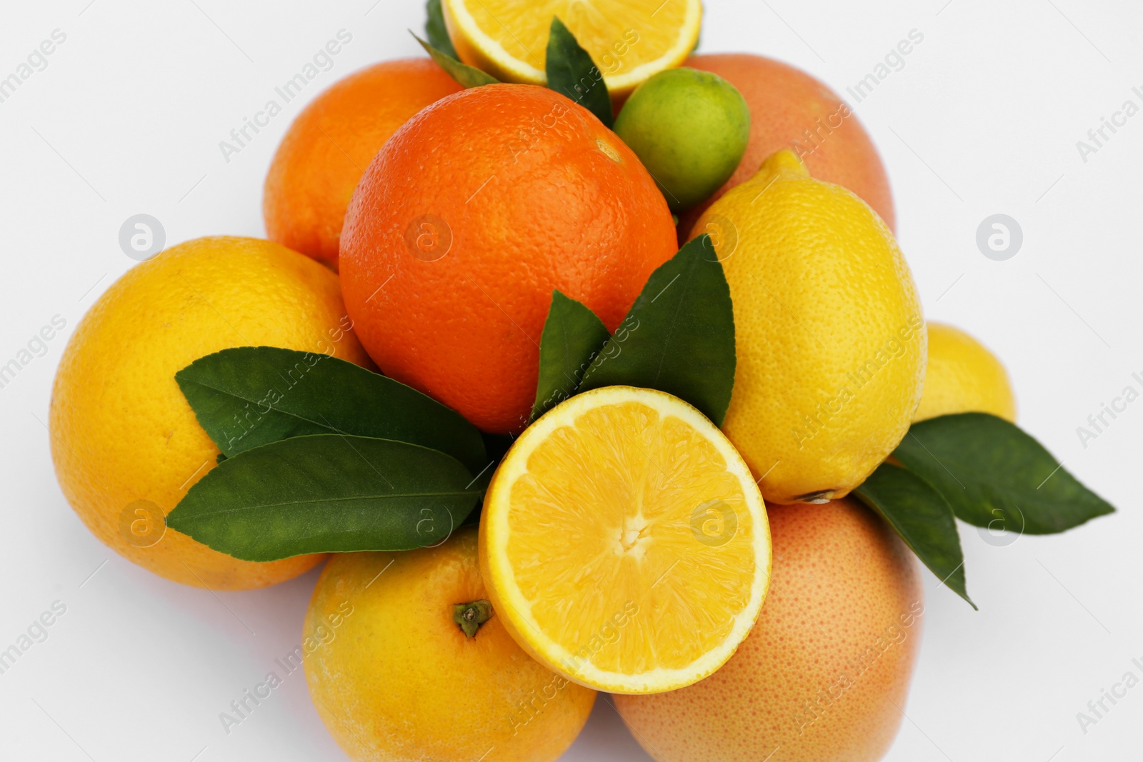 Photo of Different citrus fruits and leaves on white background, closeup