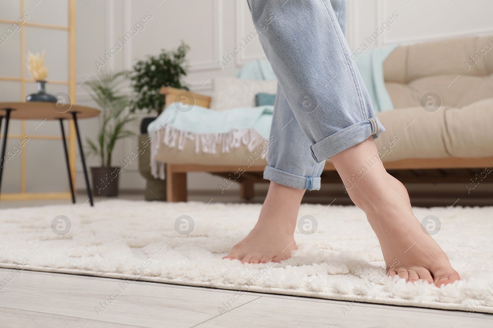 Photo of Woman standing on beige carpet in room, closeup. Space for text