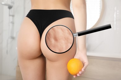 Cellulite problem. Slim woman in underwear holding orange at home, closeup. Zoomed skin with dimples, view through magnifying glass