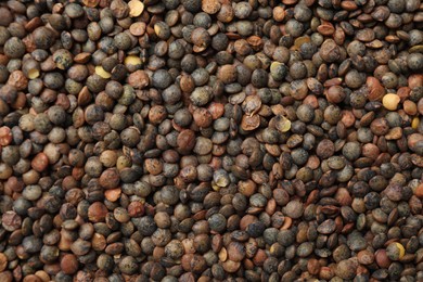 Photo of Heap of raw lentils as background, top view