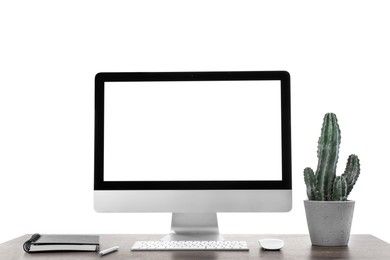 Photo of Computer, potted cactus and notebook on table against white background. Stylish workplace