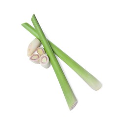 Photo of Whole and cut fresh lemongrass on white background, top view