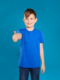 Portrait of little boy on color background