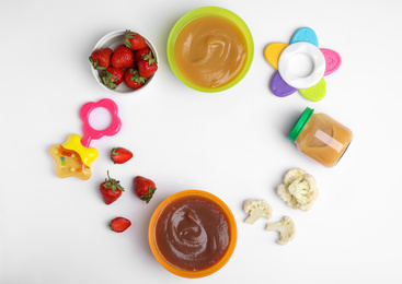 Photo of Frame of baby food, ingredients and toys on white background, flat lay. Space for text