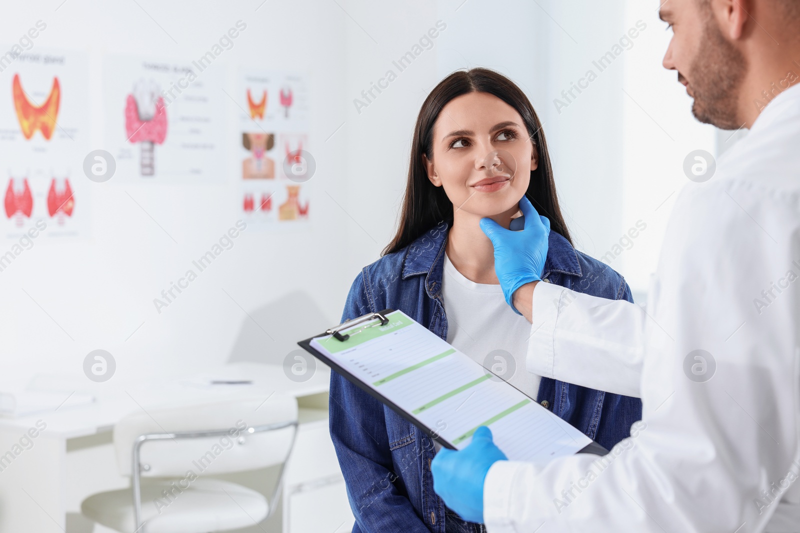 Photo of Endocrinologist with clipboard examining thyroid gland of patient at hospital, space for text