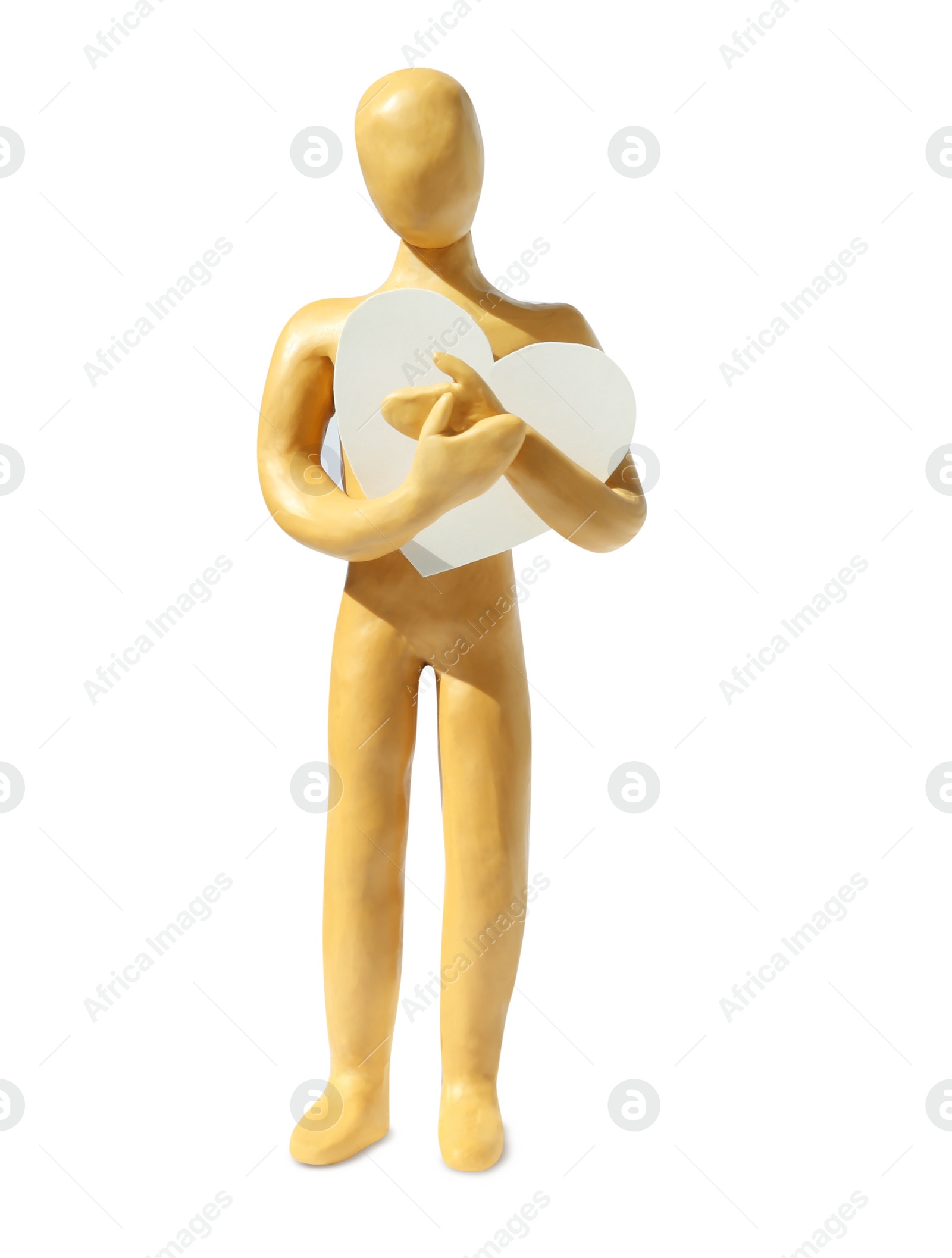 Photo of Yellow plasticine human figure with paper heart isolated on white