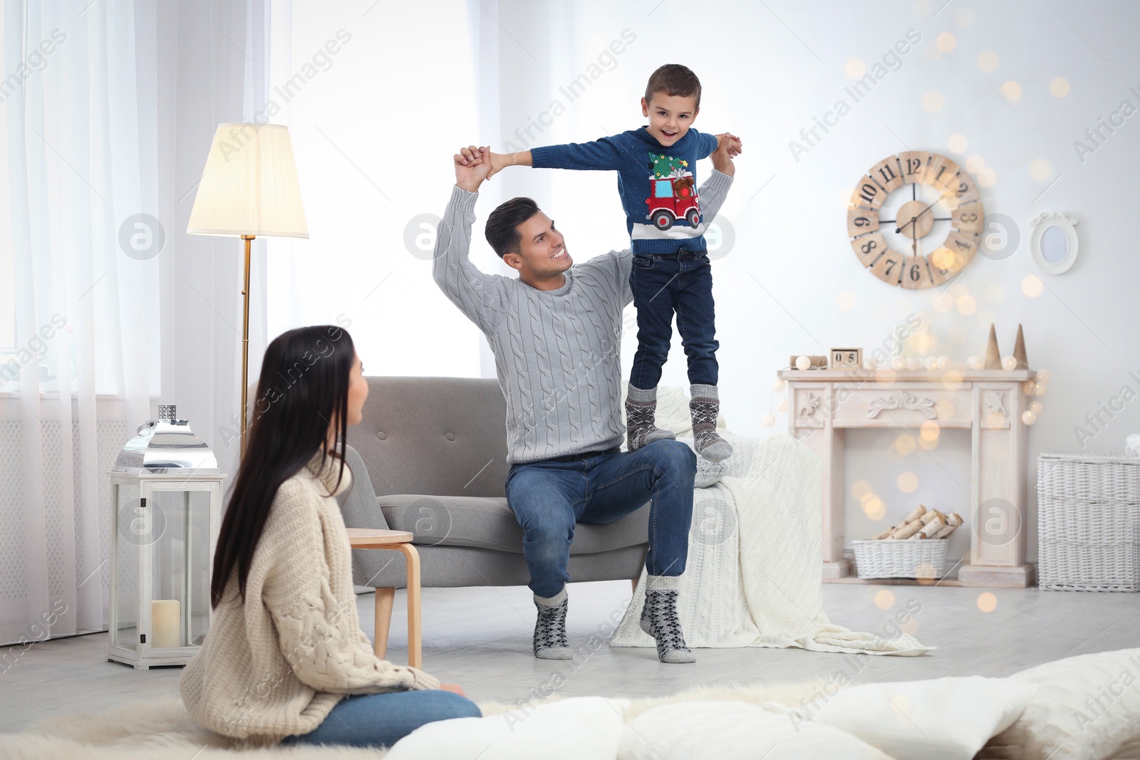 Photo of Happy family with little son having fun at home. Winter vacation