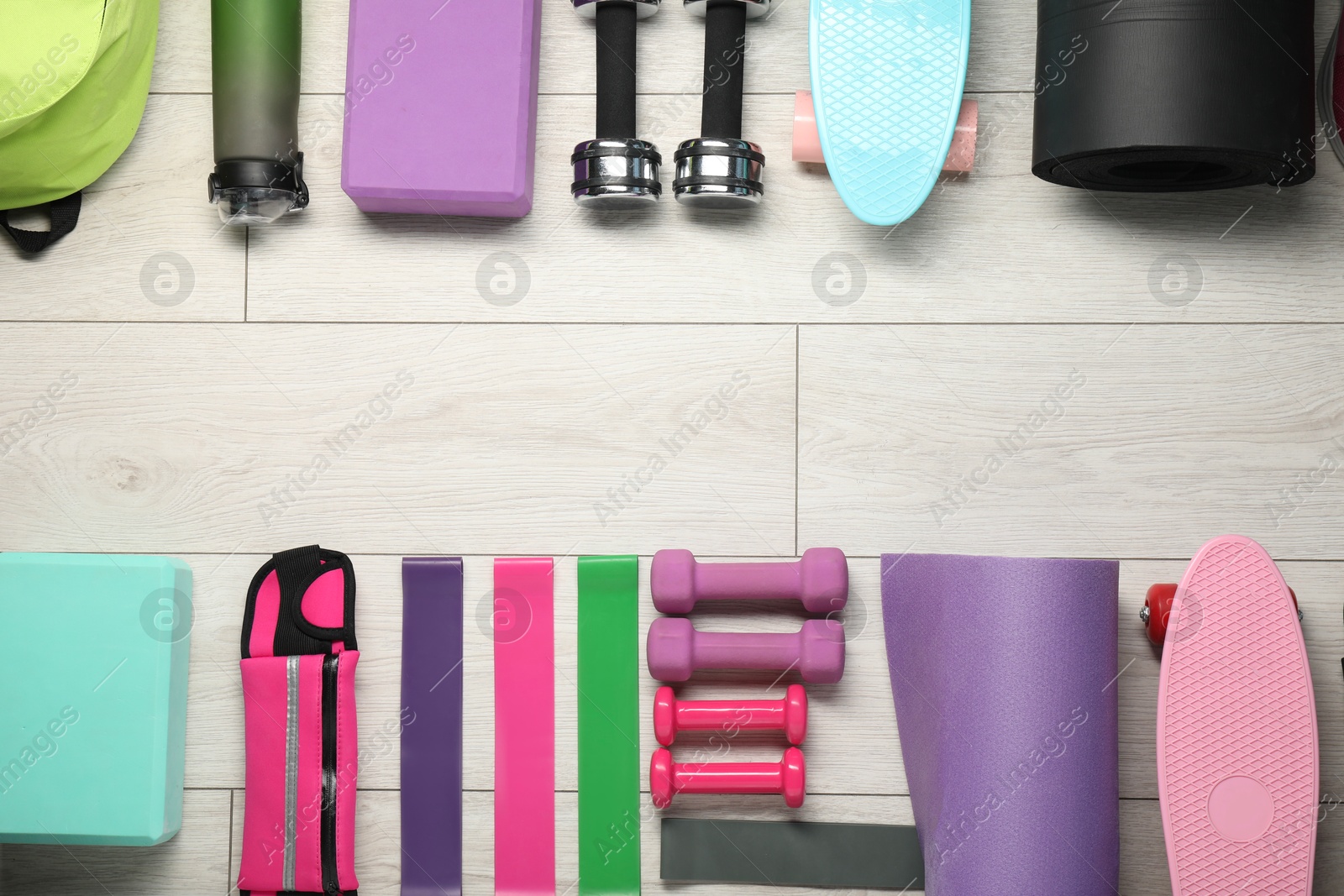 Photo of Frame of different sports equipment on white wooden table, flat lay. Space for text