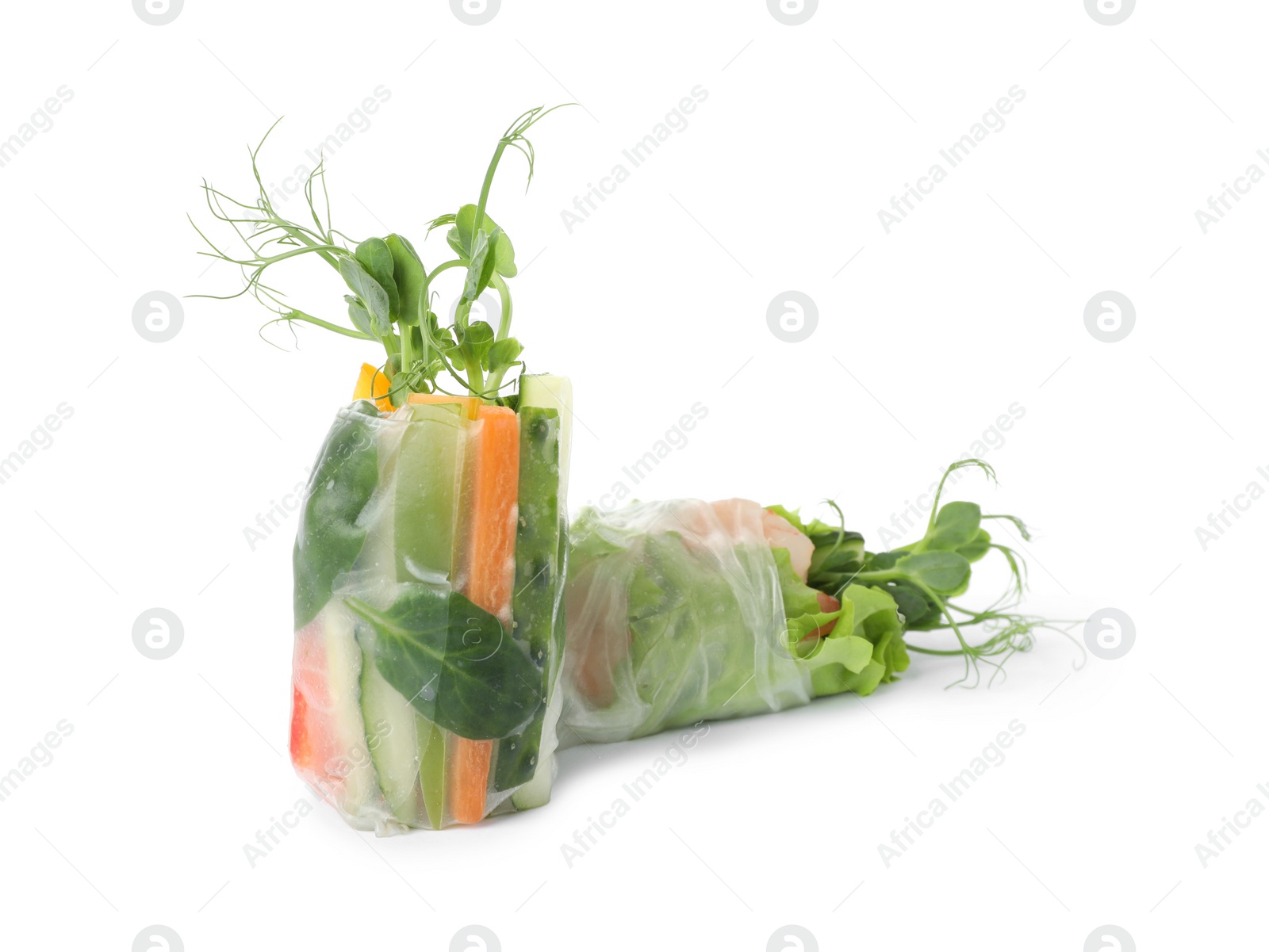 Photo of Delicious rolls wrapped in rice paper isolated on white