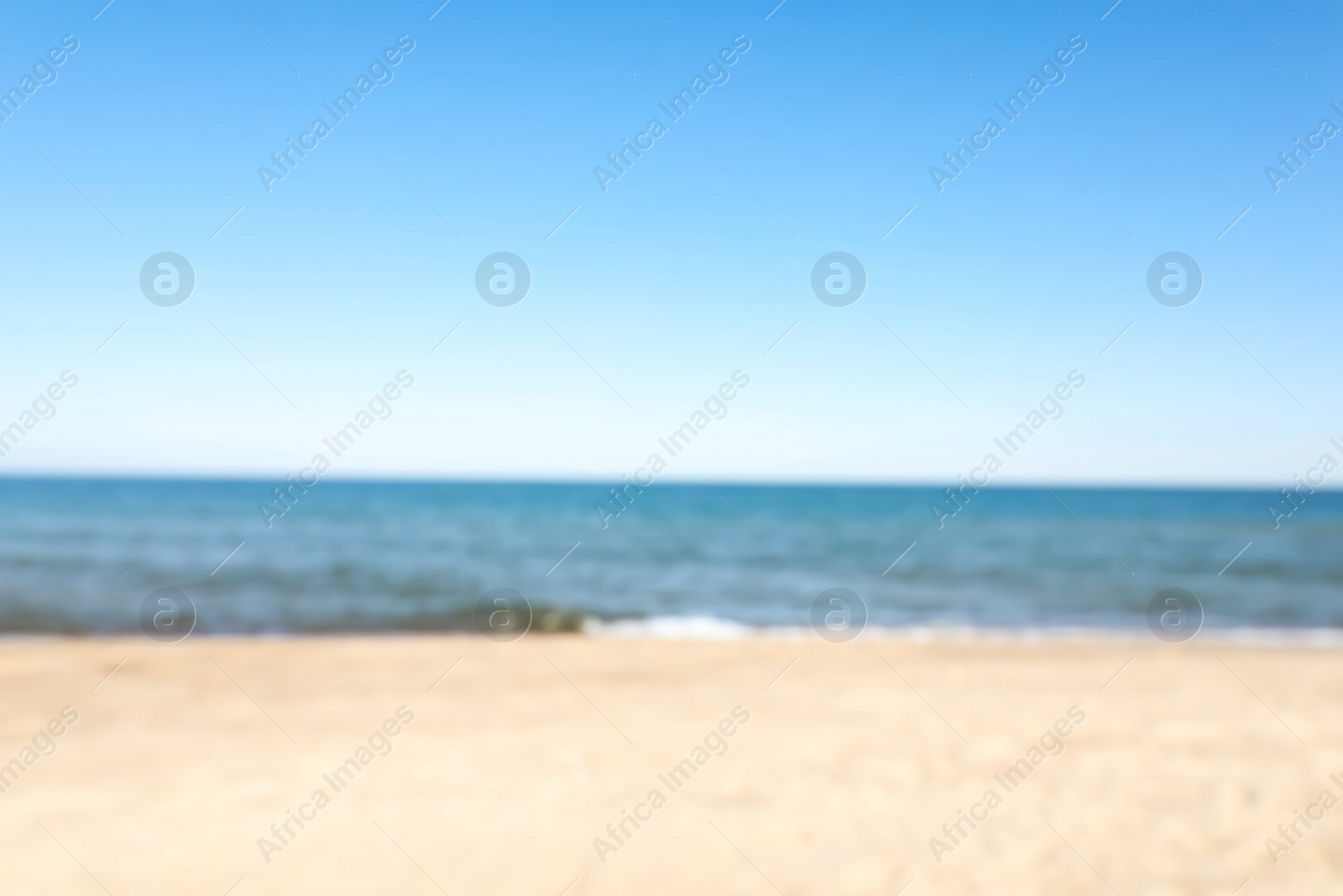 Photo of Blurred view of sandy beach near sea