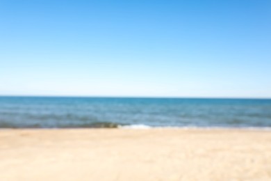 Photo of Blurred view of sandy beach near sea