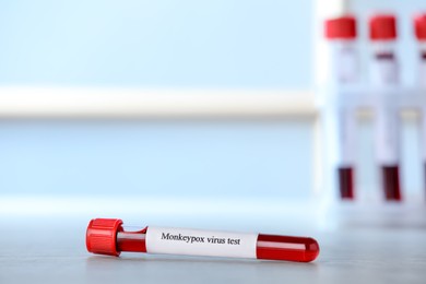 Monkeypox virus test. Sample tube with blood on table, space for text