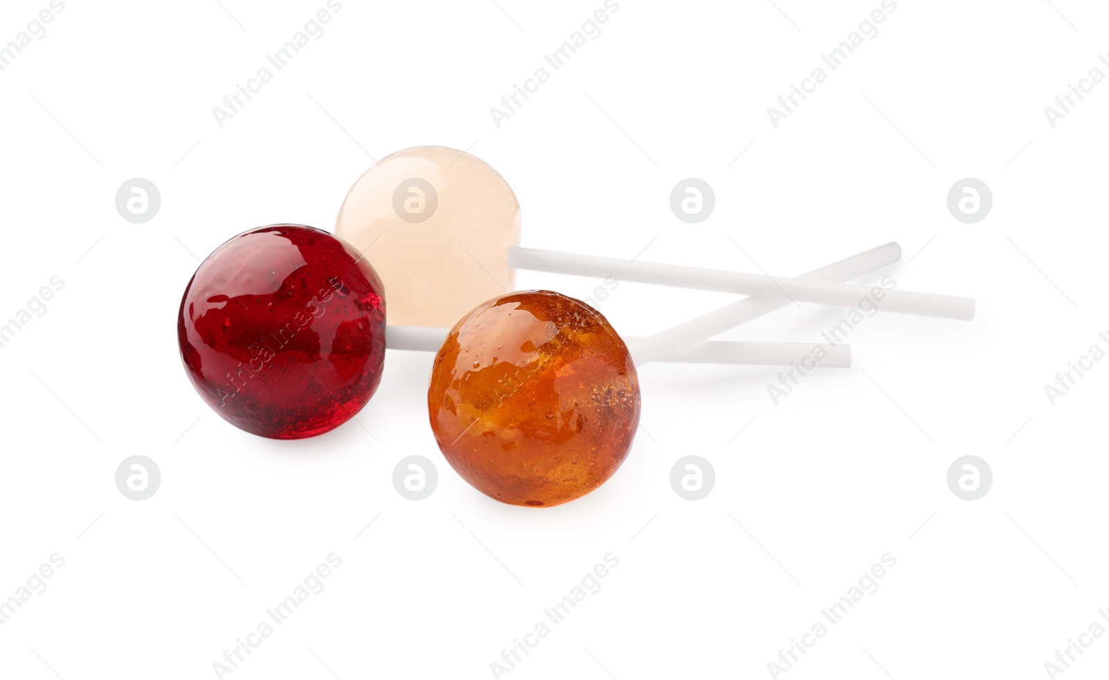 Photo of Three tasty colorful lollipops isolated on white