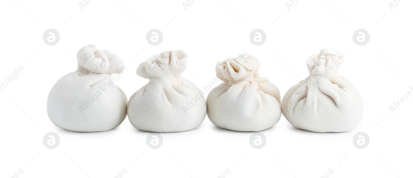 Photo of Uncooked khinkali (dumplings) isolated on white. Georgian cuisine