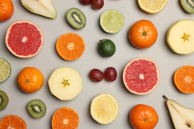 Photo of Different ripe fruits on light gray background, flat lay
