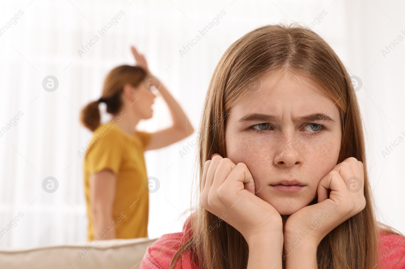 Photo of Mother scolding her teenager daughter at home