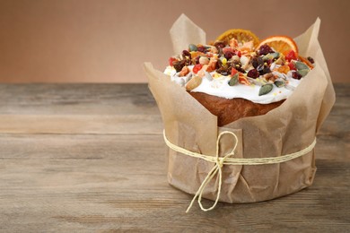 Traditional Easter cake with dried fruits on wooden table, space for text