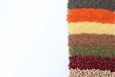 Different grains and cereals on white background, top view