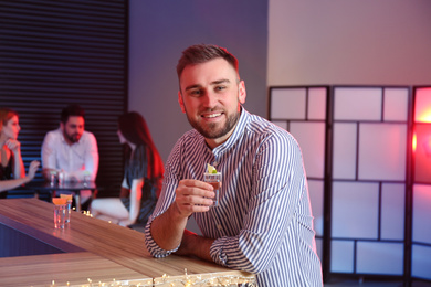 Photo of Young man with Mexican Tequila shot at bar