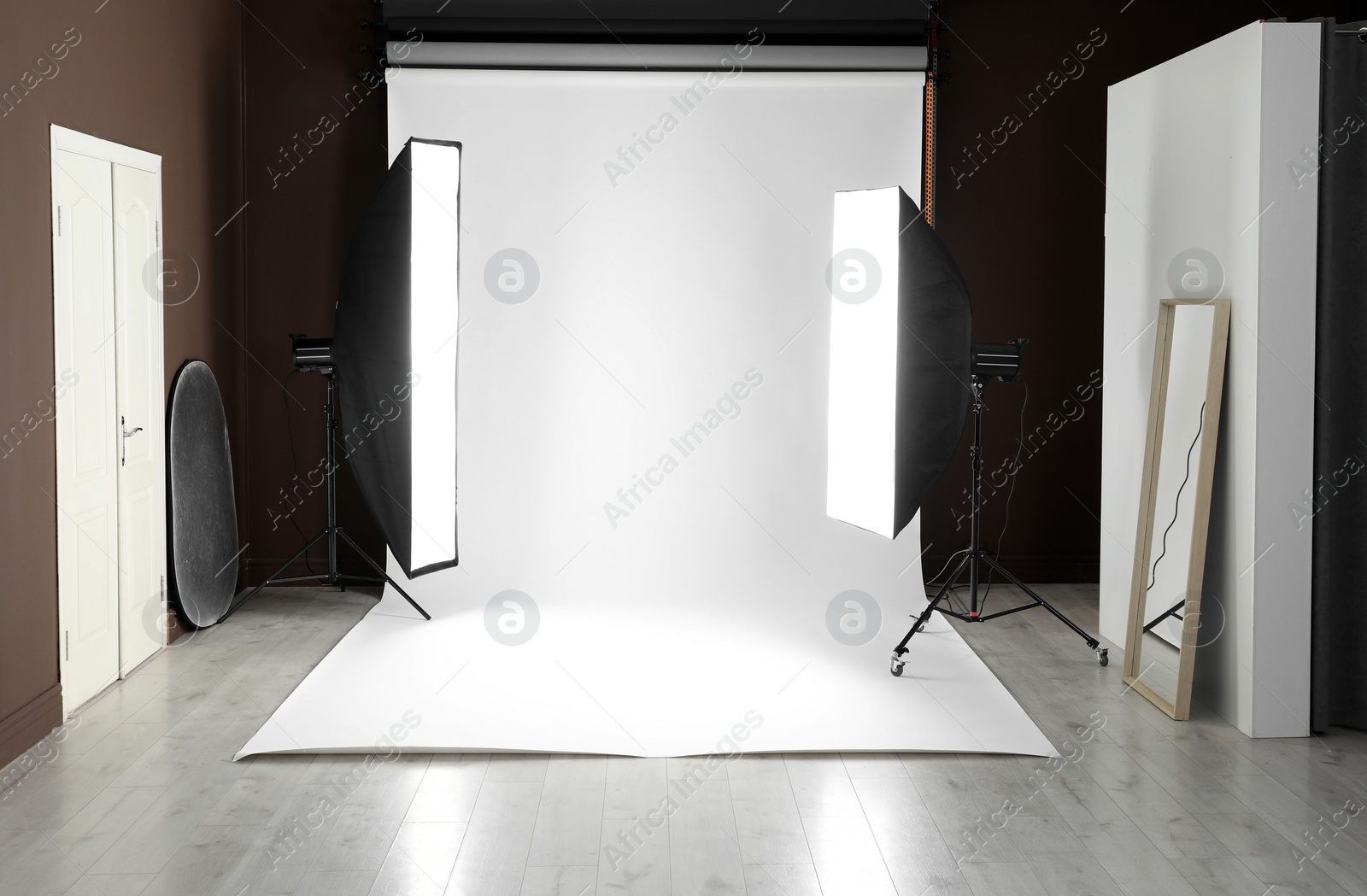 Photo of White photo background and professional lighting equipment in studio