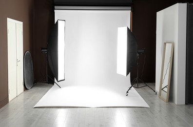 Photo of White photo background and professional lighting equipment in studio