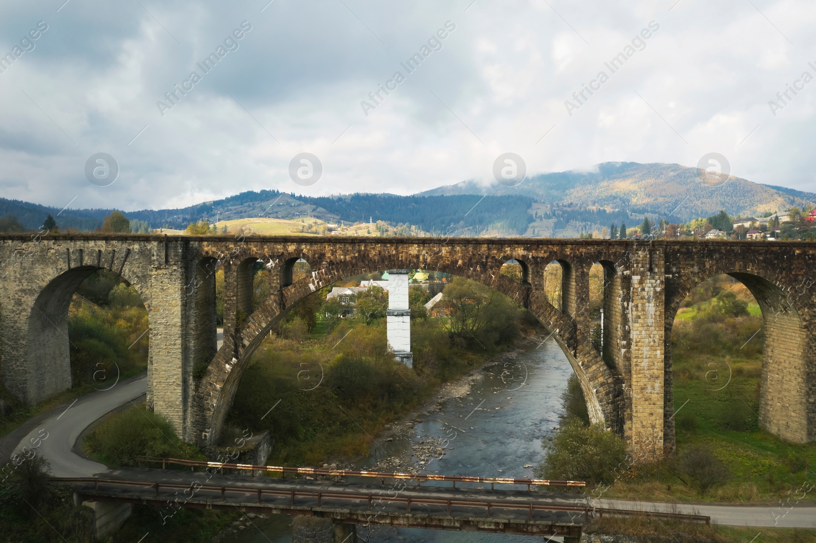 Image of Aerial view of bridges over river on autumn day